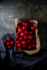 Delicious and Juicy Red Plums.

Vibrant red plums, ripe and ready to eat, arranged in a wooden...