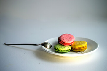 A set of delicious fresh colorful macaroons with different flavors lying on the plate