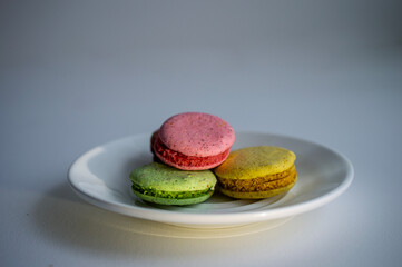 A set of delicious fresh colorful macaroons with different flavors lying on the plate