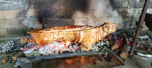 Maialetto, little pig cooking on the fire