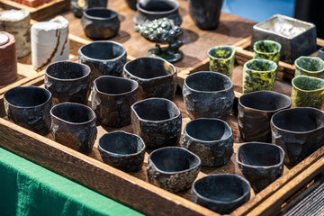 Unique Handmade Ceramic Cups Displayed at Artisan Market for Sustainable Living Enthusiasts