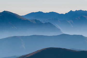 Aerial view of the hazy, layered mountain ranges fading into the horizon in cool blue tones, VysokÃ© Tatry, PreÅ¡ov Region, Slovakia.
