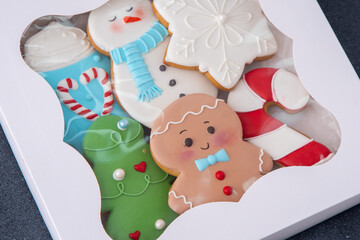 Christmas Cookie Gift Box with Decorated Treats Gingerbread decorated icing Food background. Christmas tree cookies.