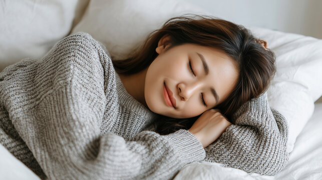  Young asian woman sleeping in cozy bed
