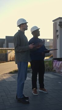 The managers of the construction company evaluate the result of the work standing near the object