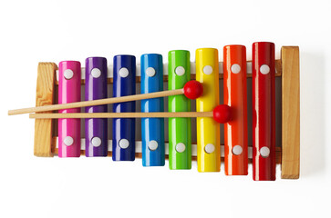 Children's xylophone with colored strips and two sticks.