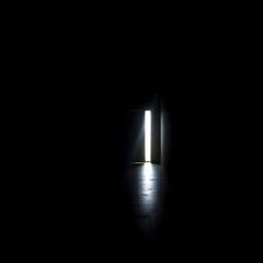 a solitary sliver of bright light cutting through the oppressive darkness,