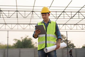 inspector or engineer is inspecting construction and quality assurance new house using a tablet....