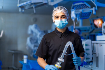 Surgeon gets ready for surgery. A young healthcare worker stands in the OR, prepared for surgery...