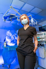 Surgeon readies for operation. A healthcare worker in surgical attire stands confidently in an...