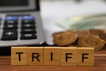 Wooden Letter Blocks Spelling TRIFF with Money and Calculator Background