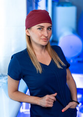 Clinic healthcare professional. A skilled healthcare worker leans against a wall in a modern...