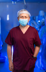 Surgeon readies for key surgery. A healthcare professional in scrubs stands confidently in a...