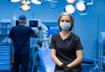 Surgical medical professional. Medical staff prepare for a crucial surgery while a nurse waits in a sterile operating room.