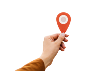 Person's hand grasping orange-red GPS location pin with white center for geographic positioning, isolated on a transparent background