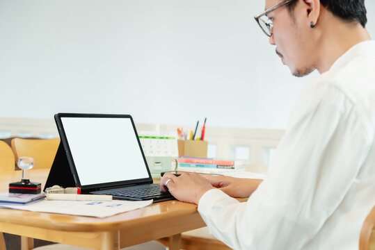 Man typing on laptop at desk, side view for telework, online, man, businessman and laptop screen in home office for articles, business news and data transmission.