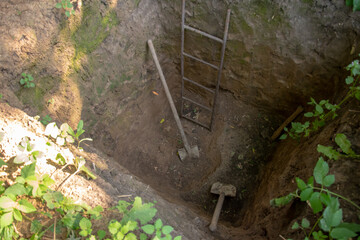 A ladder is in the middle of a hole in the ground