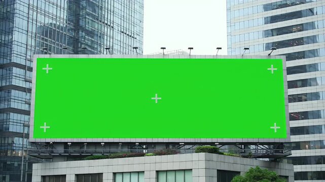 Large Green Screen Billboard Mockup with Tracking Markers in Modern Cityscape for Advertising and Promotion