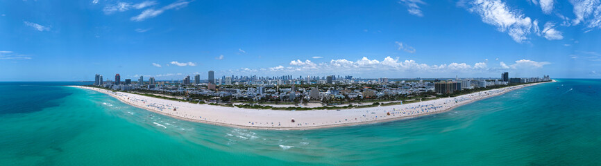 Aerial view of South Beach coastline. Miami skyline with tropical blue waters panorama. Panorama over the Miami skyscrapers. Miami, Florida waterfront cityscape. Iconic South Florida travel