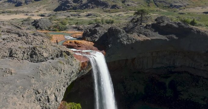 Man stands at the top of the Salto del Agrio waterfall. Neuquen, Patagonia Argentina
