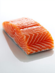 Raw salmon fillet on white surface
