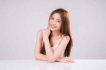 Obraz premium Skin Care Woman Asian Person Smile White Beauty Young Portrait Face Background, Confident and Radiant Female Model with Healthy Skin On White Background