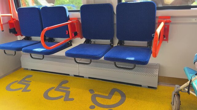 Folding seats for disabled people allow other passengers to sit when the designated area is unoccupied, optimizing space and improving accessibility on public transport