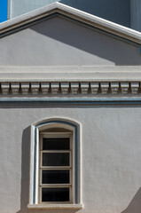 Arched Window and Facade in an Old White Building.