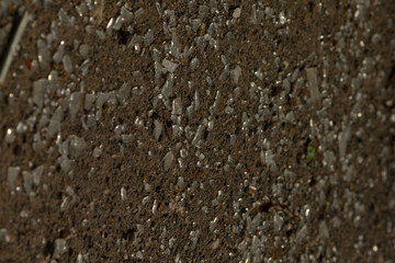 This is a detailed closeup view of a concrete surface that features an abundance of small, varied rocks scattered across it
