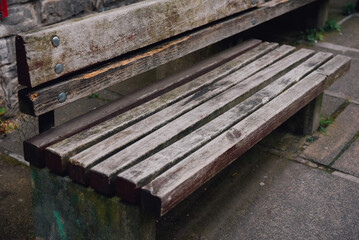 Rustic wooden bench for sitting in public areas.