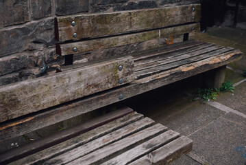 Rustic wooden bench for sitting in public areas.