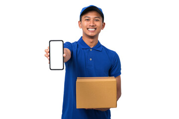 Asian delivery man wearing blue uniform holding cardboard box showing smartphone with blank screen