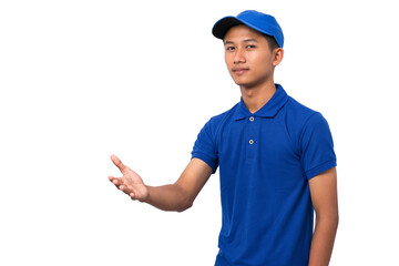 Smiling young asian delivery man wearing blue uniform pointing present a product