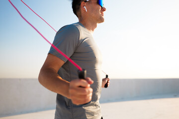 Runner enjoying a bright morning jump rope workout on a rooftop terrace