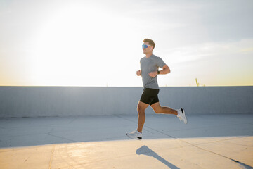 Running towards the sunset on a warm evening, embracing the joy of fitness