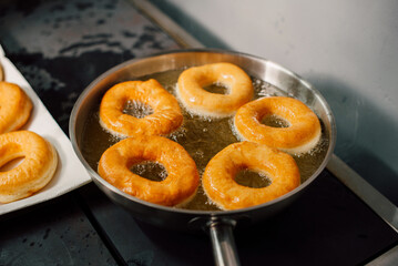 Golden doughnuts are flawlessly frying to perfection, emphasizing the ultimate culinary delight of delicious treats