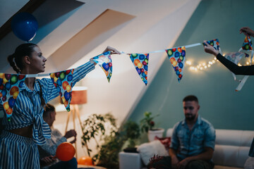 A group of people preparing decorations for a birthday party at home, creating a festive and cheerful atmosphere with colorful balloons and warm lights in their cozy living space.