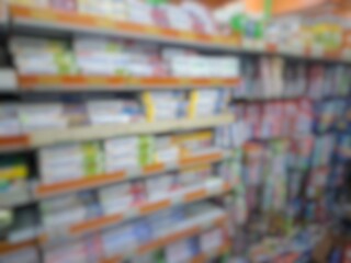 Blurry image of a supermarket aisle with shelves full of products. An abstract retail background for business, shopping, supermarket concepts, or consumer markets.