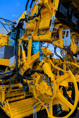 Agricultural machinery and parts of mechanisms on a sunny day. Texture, background for design. 
