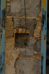 This is a detailed closeup view of a brick wall, which interestingly features a notable hole that is visible within the bricks