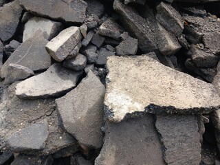 The texture of broken asphalt on the street during the day