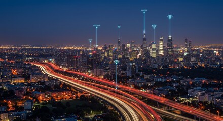 Fototapeta premium Aerial night view of a bustling metropolis with glowing streaks of vehicle lights and projected signal lines over tall structures