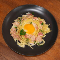 Spaghetti Carbonara Spaghetti noodles tossed in a thick creamy sauce, bacon and egg yolks are often...