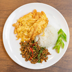 Pad Krapow is usually served with rice and an omelet.