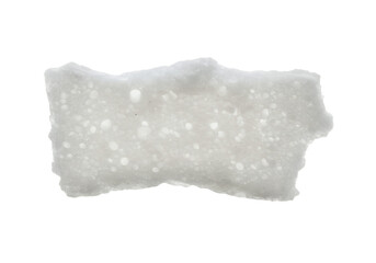 A porous opaque white block shape with uneven edges on a black background