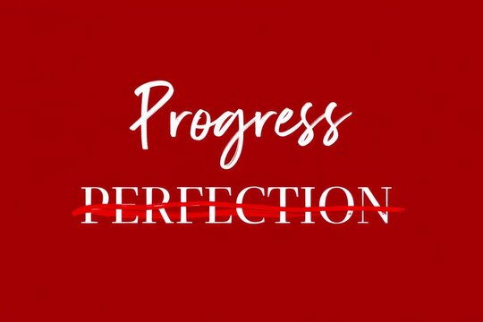 Text encouraging progress over perfection, with Perfection crossed out and Progress written above on a textured red paper background.