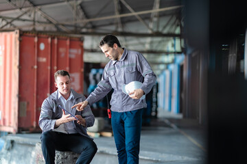 Professional warehouse staff reviewing data and shipping details. Useful for content related to...