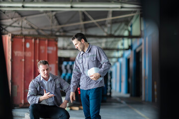 Two logistics managers coordinating real-time shipping data in a large warehouse. Suitable for...