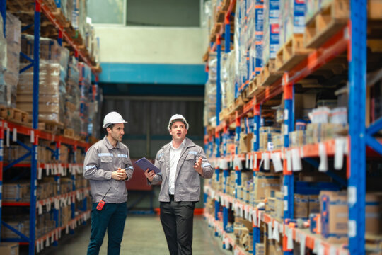 Industrial supervisors evaluating inventory and discussing task flow. Perfect for large-scale transport service content and SaaS logistics ads. - Powered by Adobe