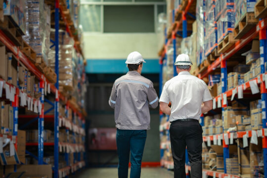 Supply chain discussion scene in storage zone. Ideal for marketing content on delivery solutions, warehouse operations, and logistics consulting.